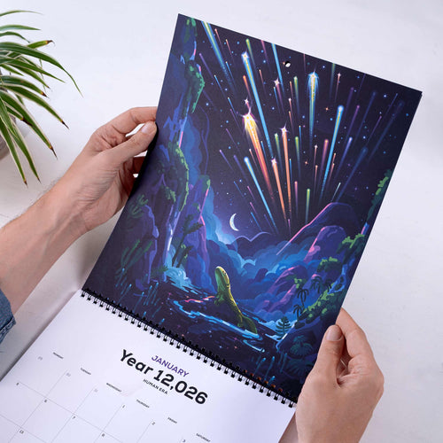 Calendar with a cosmic landscape design held by hands on a white surface.
